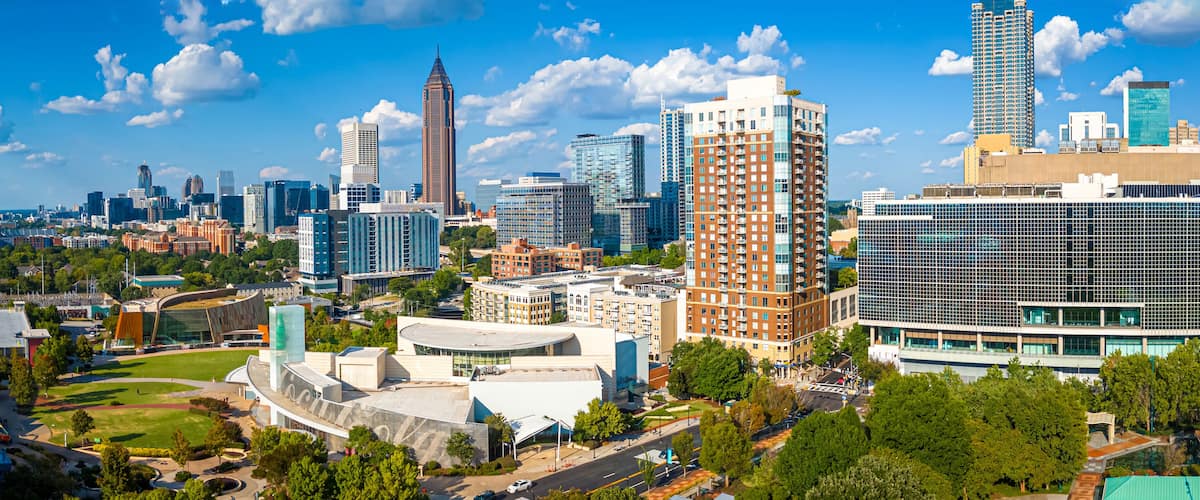 A cityscape with modern architecture, including a distinctive curved building and a tall skyscraper.
