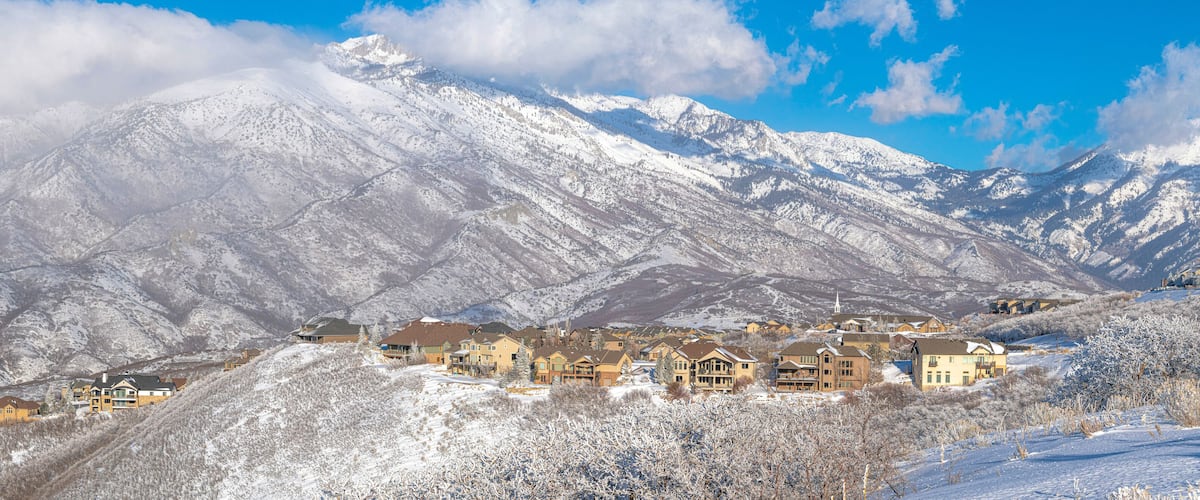 A snow-covered mountain range with a town nestled at its base.