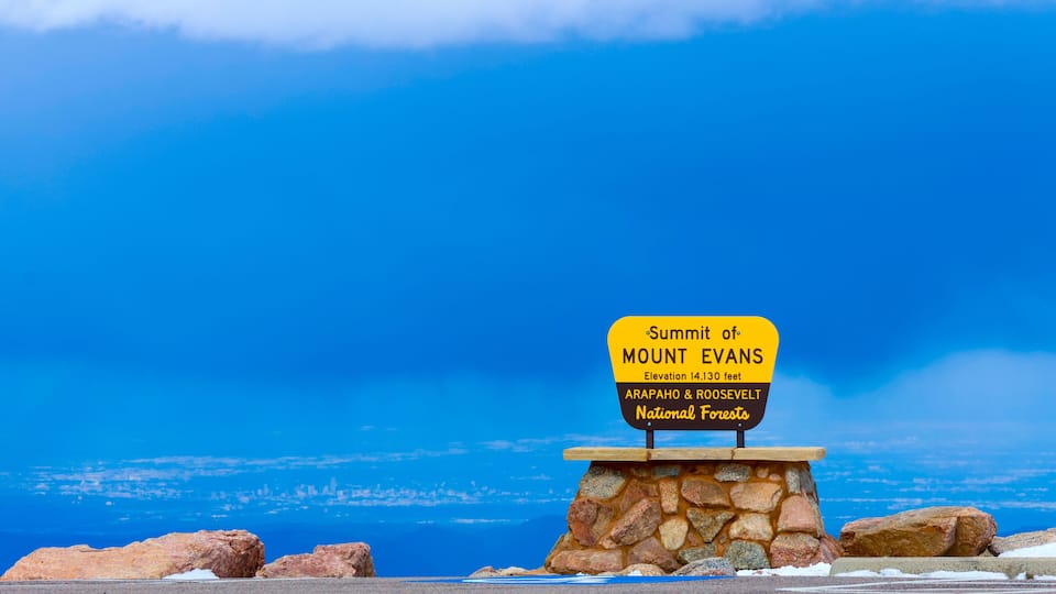 A sign at the summit of Mount Evans with an elevation of 14,300 feet, located in the Arapaho & Roosevelt National Forests.