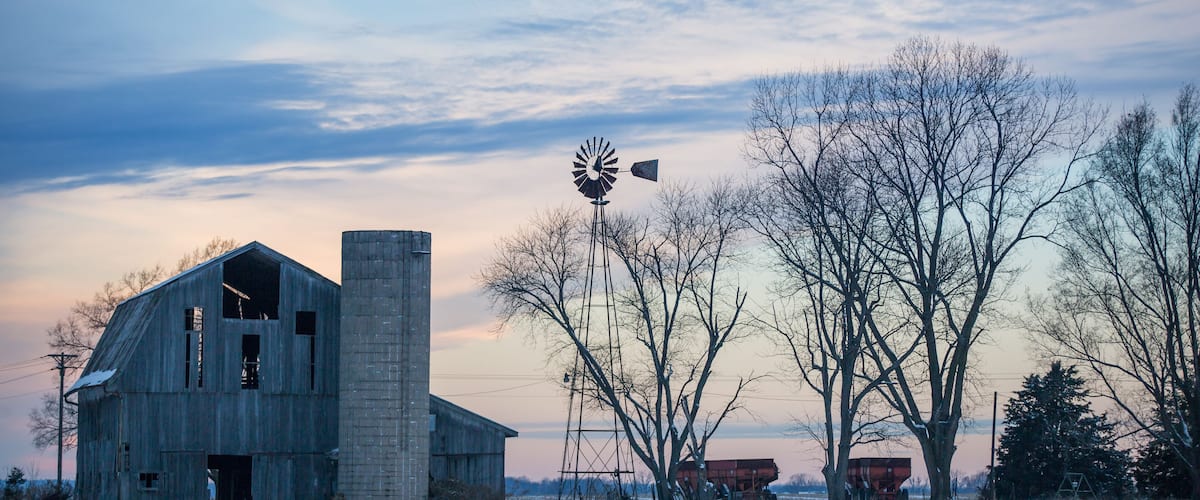 Cloudy Winter Dusky Sky over Old Derelict Farm and Windmill.
