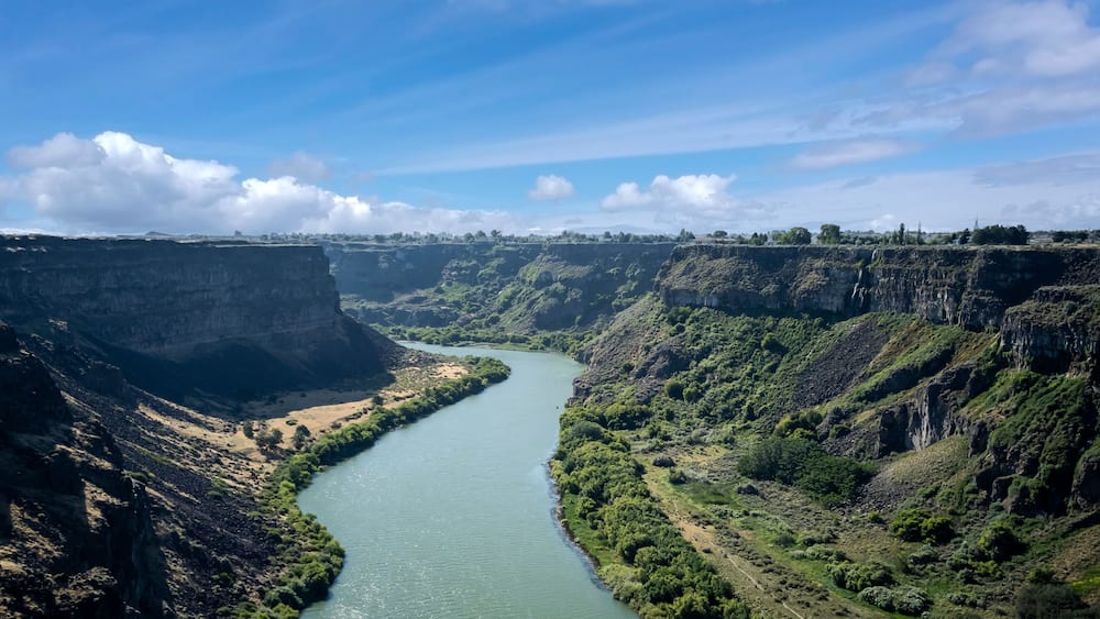 Winding Snake River flowing thru the pacific northwest in the summertime on a partly cloudy day