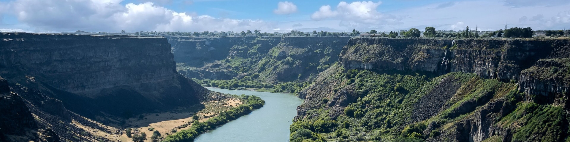 Winding Snake River flowing thru the pacific northwest in the summertime on a partly cloudy day