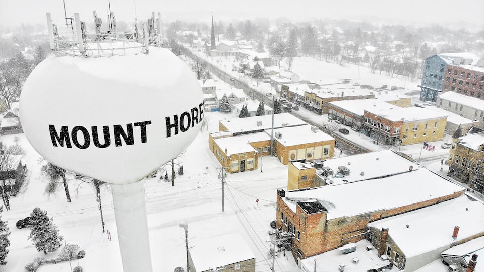 A snowy town with a prominent water tower labeled "Mount Horeb."