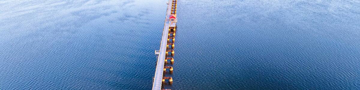 Trestle trail in neenah wisconsin extends over a small lake to another city