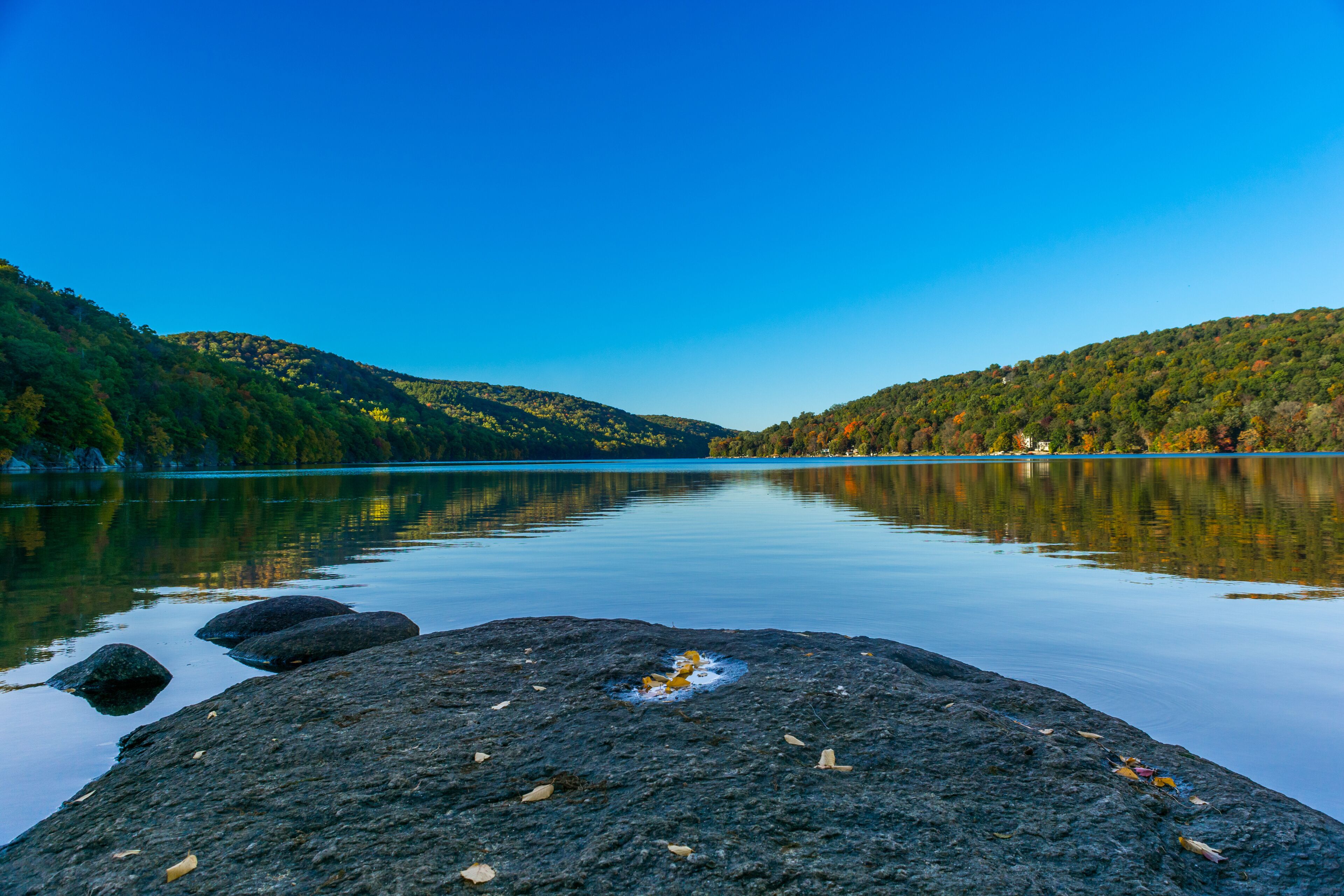 Squantz Pond New Milford Connecticut. Clear Blue Sky and still reflective waters