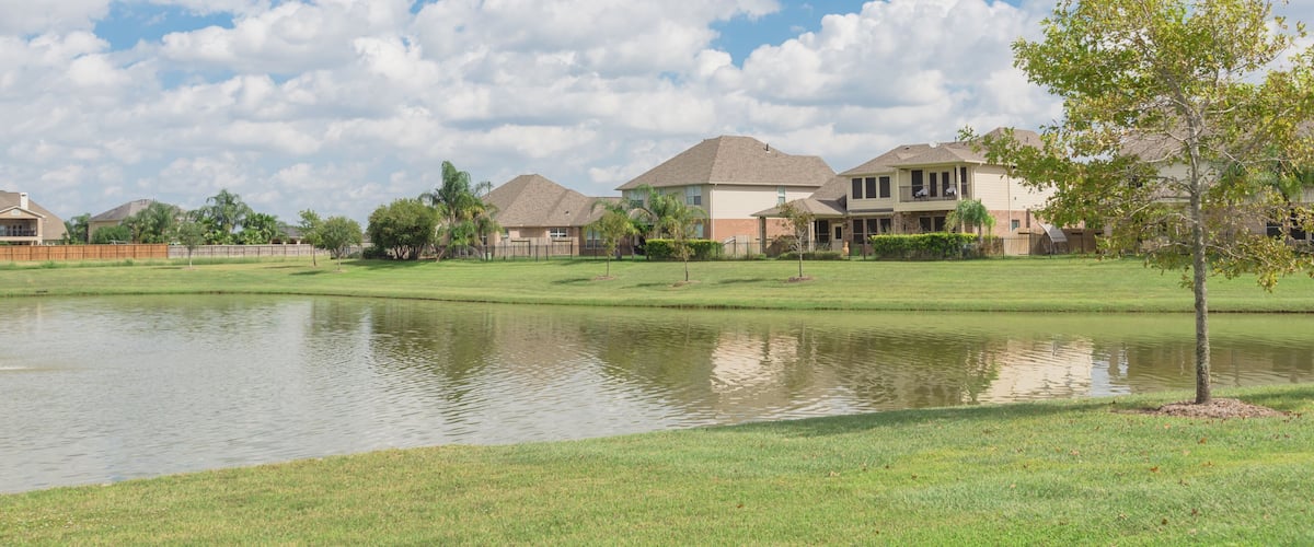 Residential houses by the lake in Pearland, Texas, USA. Panorama style.