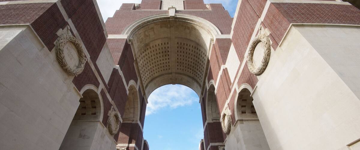 An arched gateway with brick and stone construction, leading to a higher platform.