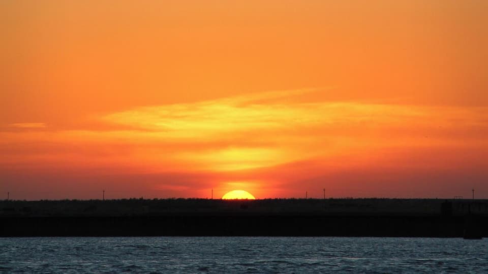 Brilliant orange sunset on a Saturday evening looking across Aransas Pass. #sunset #beachbound
