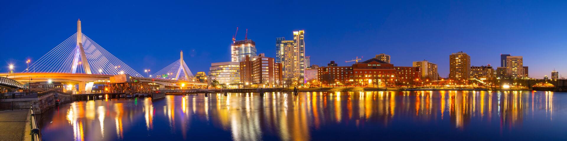 Boston Leonard P. Zakim Bunker Hill Memorial Bridge and Charles River panorama at night with twilight, Boston, Massachusetts MA, USA.