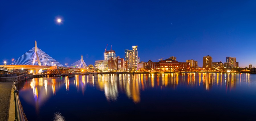 Boston Leonard P. Zakim Bunker Hill Memorial Bridge and Charles River panorama at night with twilight, Boston, Massachusetts MA, USA.
