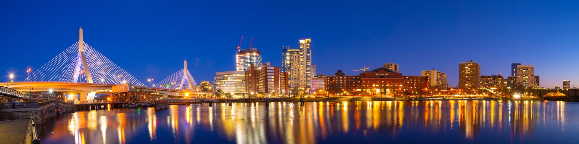 Boston Leonard P. Zakim Bunker Hill Memorial Bridge and Charles River panorama at night with twilight, Boston, Massachusetts MA, USA.