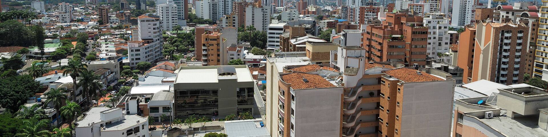 Colombia, Bucaramanga city. Panoramic View, buildings and vegetation. Overview of buildings, behind the buildings there are mountains and clear sky.