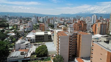 Colombia, Bucaramanga city. Panoramic View, buildings and vegetation. Overview of buildings, behind the buildings there are mountains and clear sky.