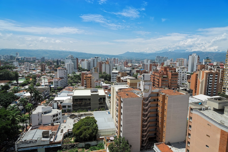 Colombia, Bucaramanga city. Panoramic View, buildings and vegetation. Overview of buildings, behind the buildings there are mountains and clear sky.