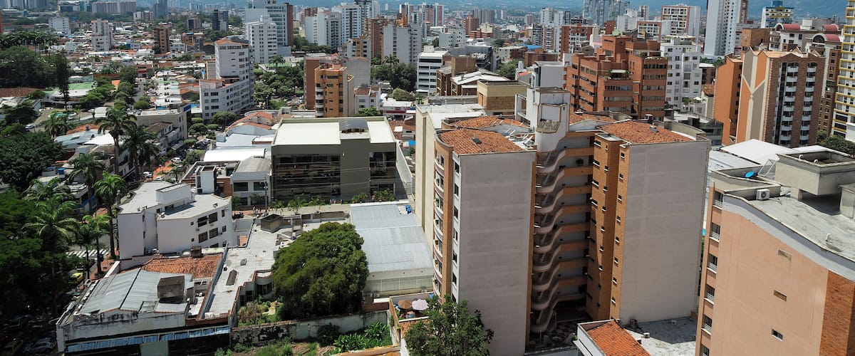 Colombia, Bucaramanga city. Panoramic View, buildings and vegetation. Overview of buildings, behind the buildings there are mountains and clear sky.