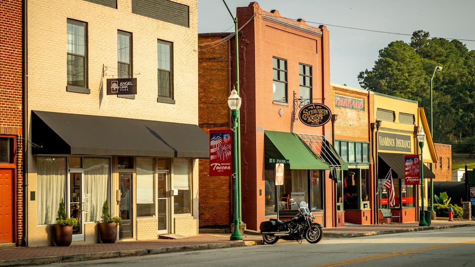 A street lined with historic buildings, including a Tocca restaurant and a Threads store.