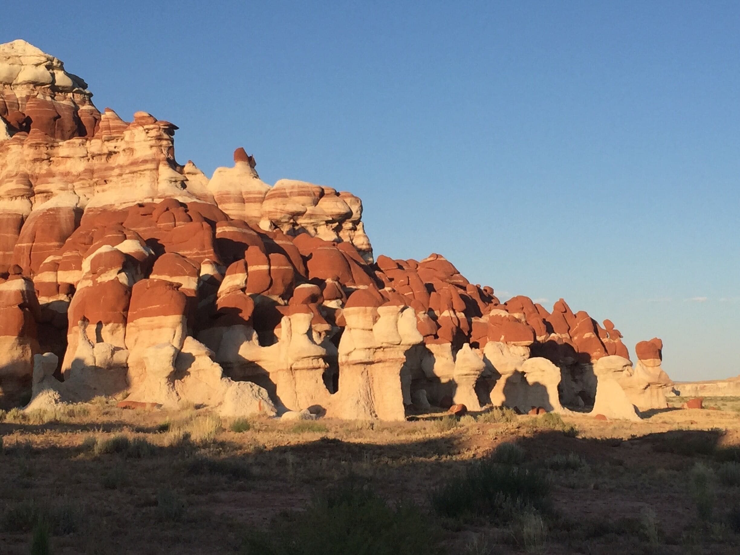 A large rock formation with layered red and white colors.