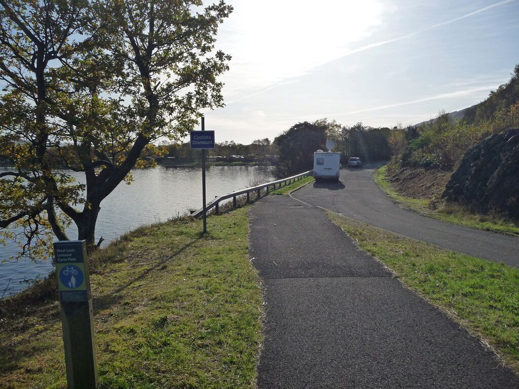 Cycle path near Inverbeg The West Loch Lomond cycle path joins a lay-by off the A82, occupied by several motor homes. The 'cyclists dismount' sign is patronising and pointless.