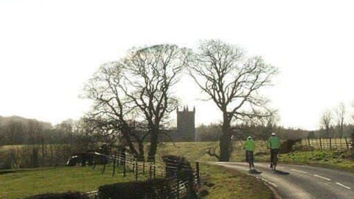 Cyclists Road from Glanton to Whittingham with the church in the distance.