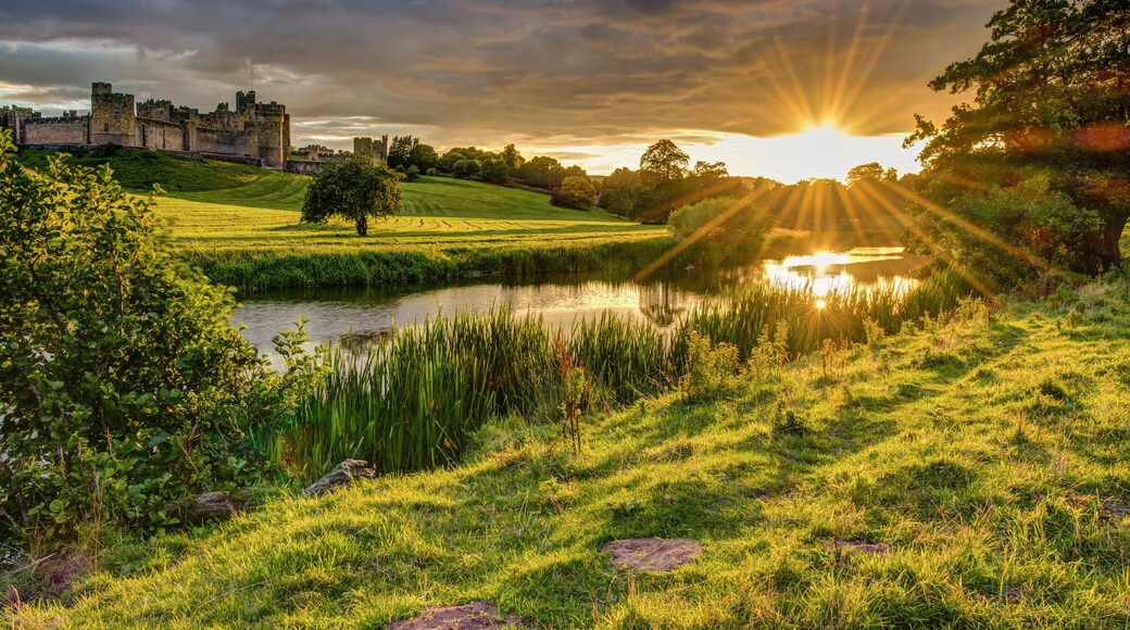 Sunbeams over River Aln at Alnwick / The River Aln runs through Northumberland from Alnham to Alnmouth. Seen here below Alnwick Town and Castle on the skyline, as the sun goes down