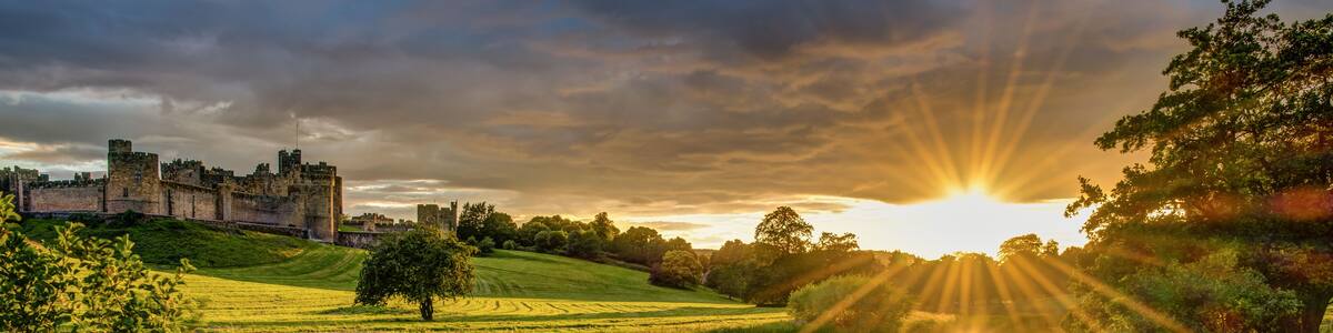 Sunbeams over River Aln at Alnwick / The River Aln runs through Northumberland from Alnham to Alnmouth. Seen here below Alnwick Town and Castle on the skyline, as the sun goes down