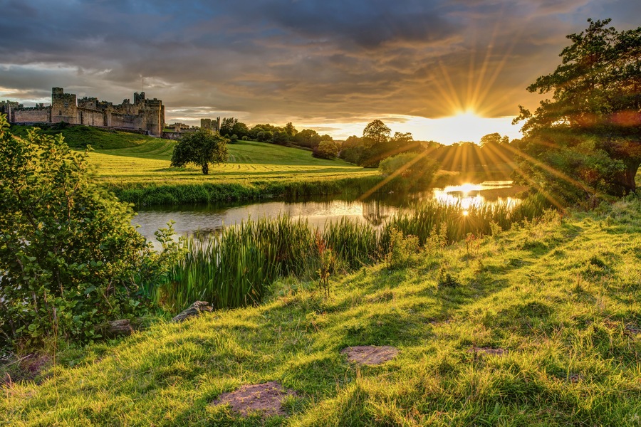 Sunbeams over River Aln at Alnwick / The River Aln runs through Northumberland from Alnham to Alnmouth. Seen here below Alnwick Town and Castle on the skyline, as the sun goes down