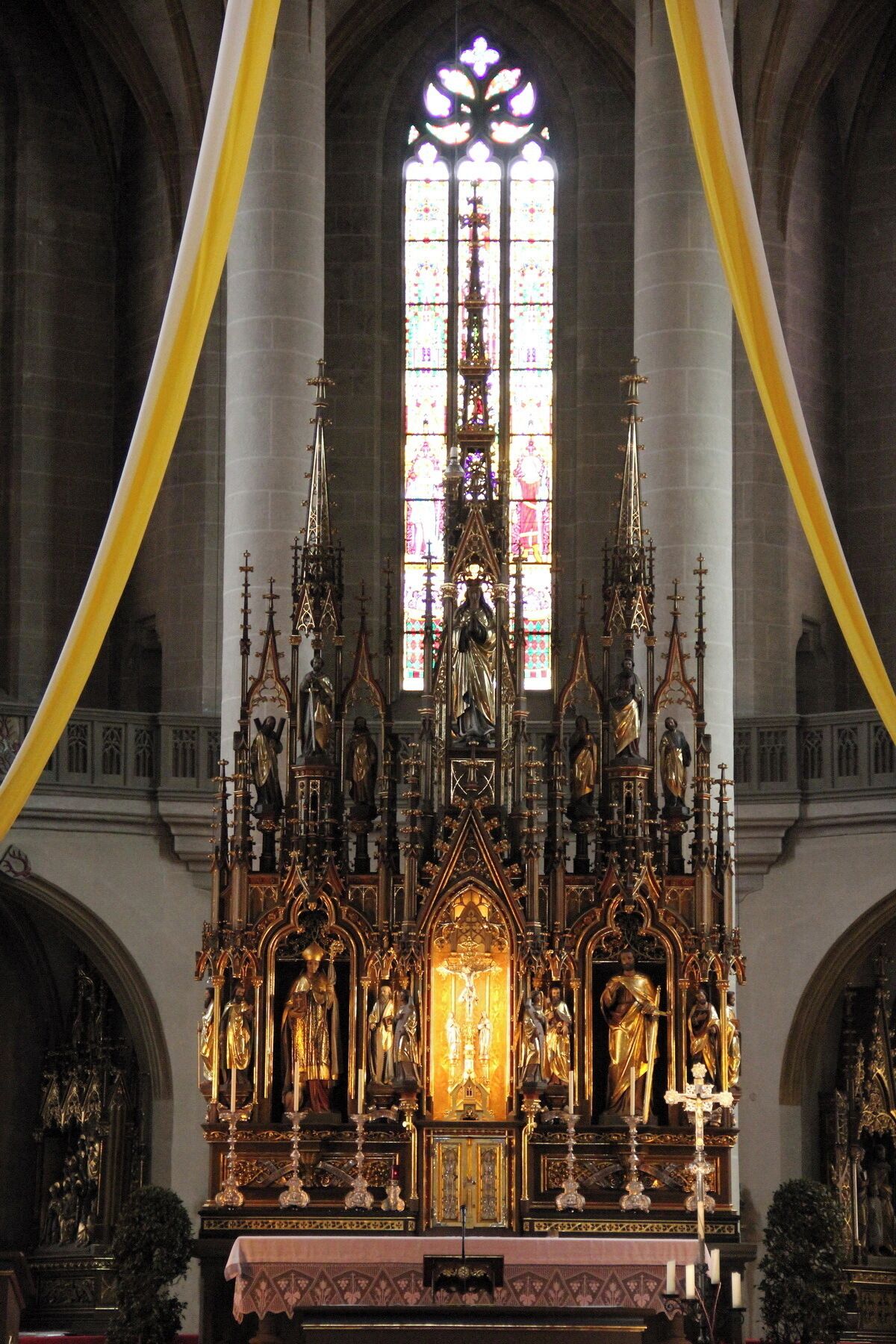A Gothic-style altar with intricate gold detailing and statues.