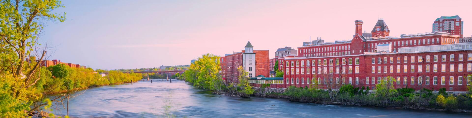 Manchester skyline, New Hampshire over the Merrimack River panorama at sunrise