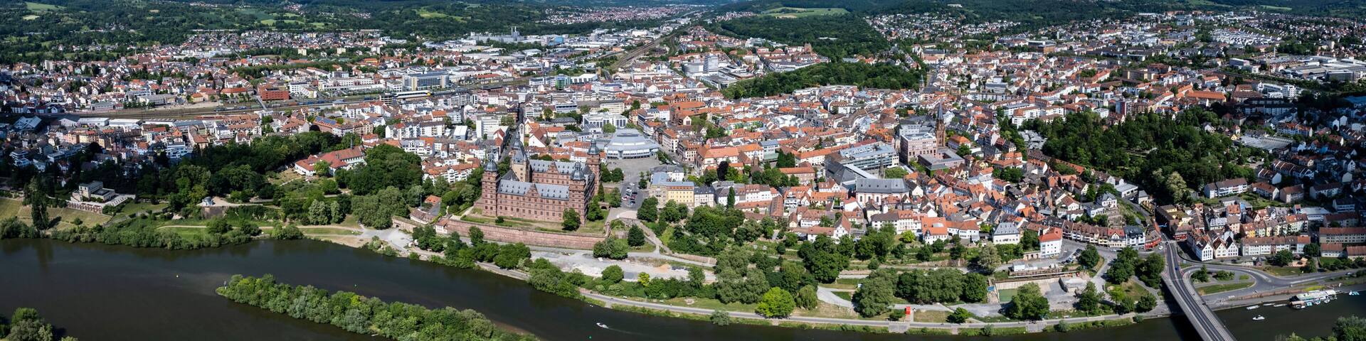 A river flowing through a city with historic buildings and a bridge.