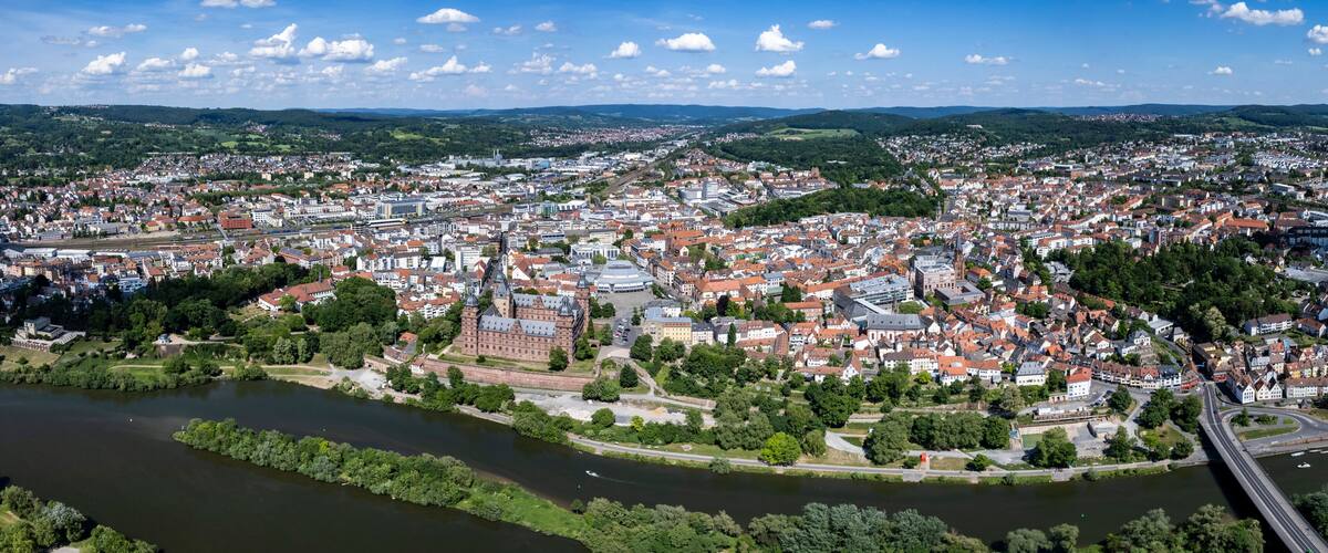 A river flowing through a city with historic buildings and a bridge.