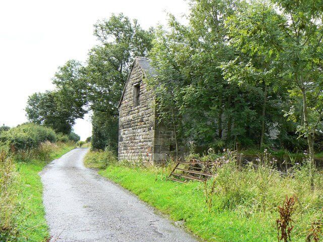 Abandoned barn A substantial stone building which appears to have fallen out of use and been left derelict.