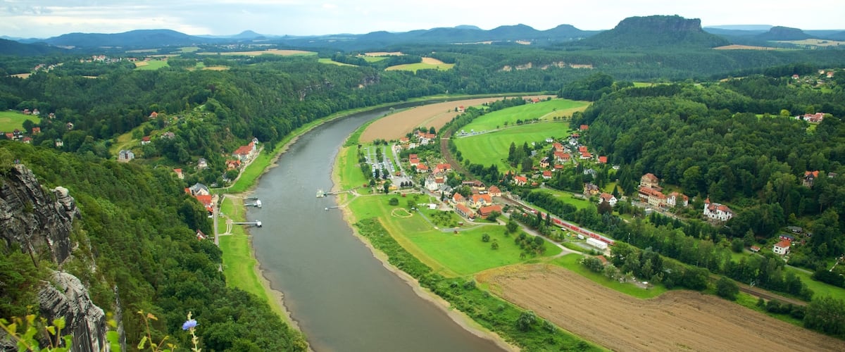 A river winding through a valley with houses and fields.
