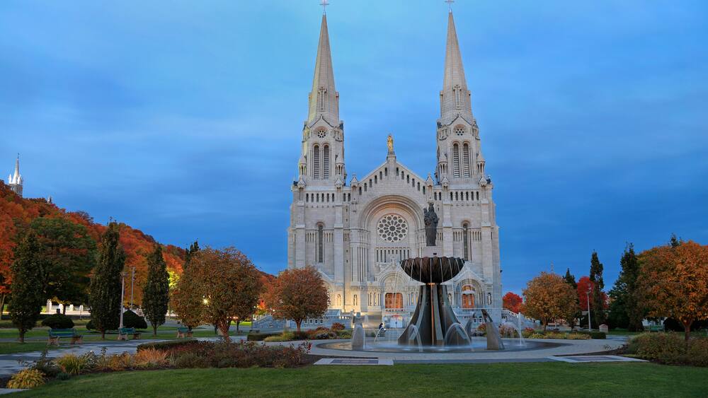 Basilica of Sainte-Anne-de-Beaupre with autumn colors on the background, Quebec, Canada