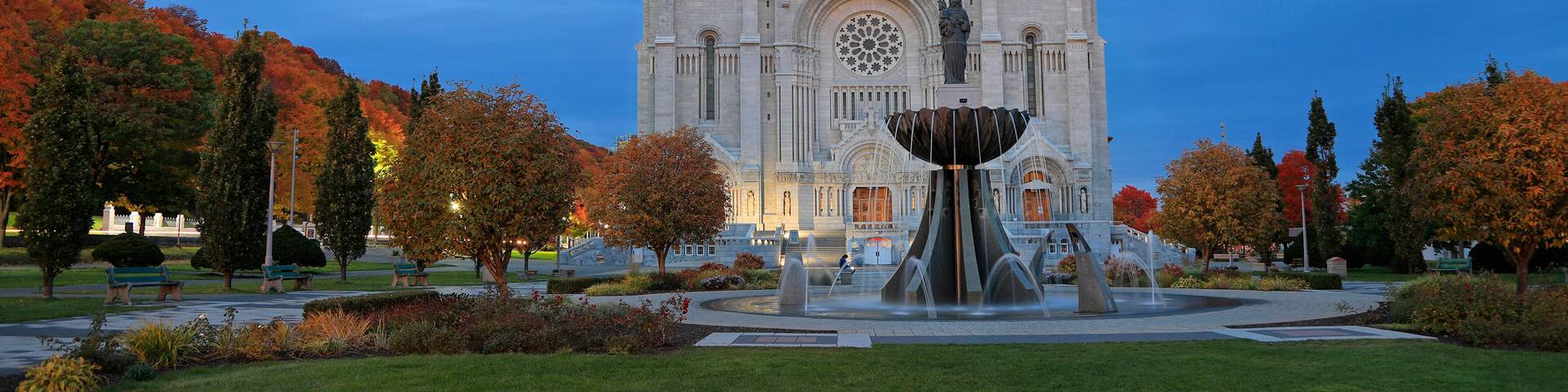 Basilica of Sainte-Anne-de-Beaupre with autumn colors on the background, Quebec, Canada