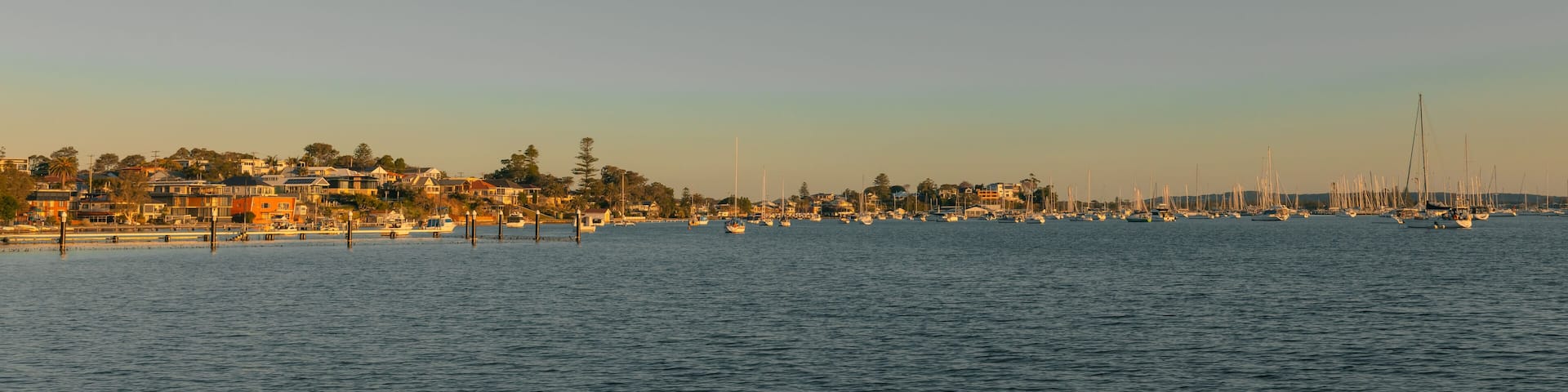 A coastal town with houses and boats on the water.