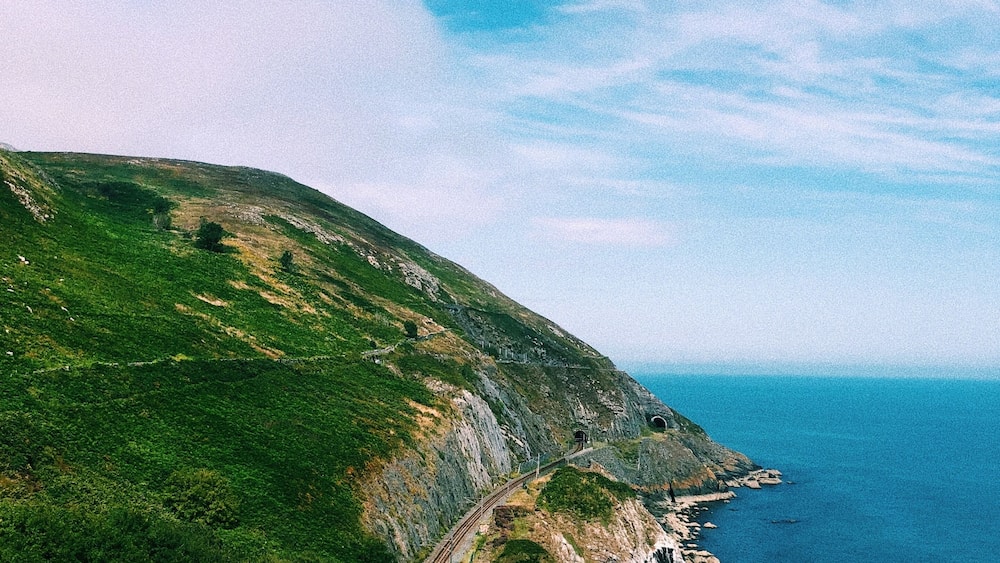 Walking from Bray to Greystones is the perfect hike to see those Irish cliffs you've always dreamed of. Can you imagine riding the train through here?! #adventure