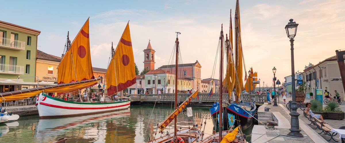 Cesenatico showing a sunset and a bay or harbor