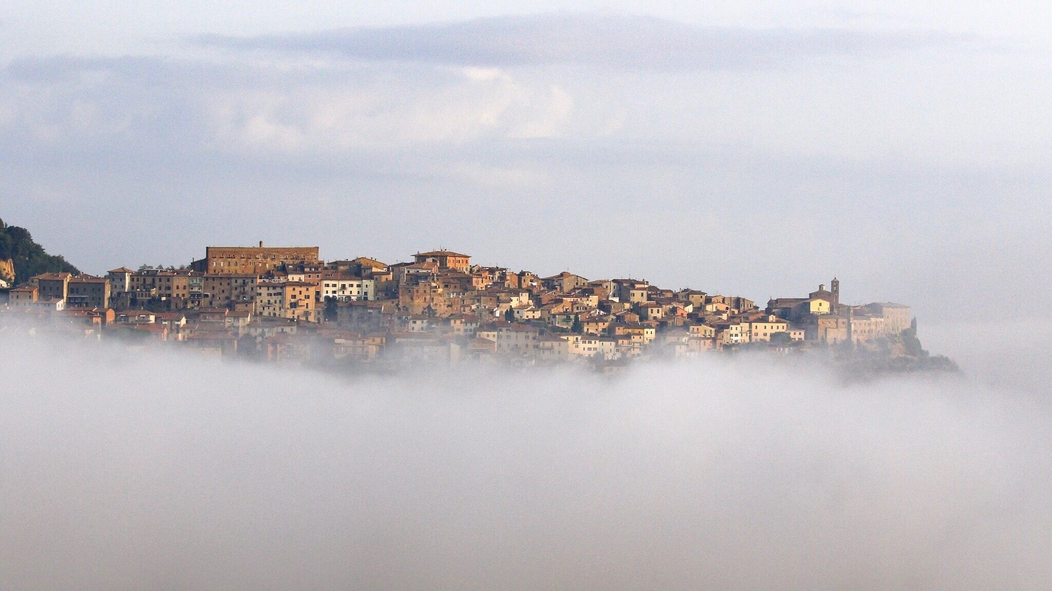 The old town of Chianciano Terme, as seen from just outside the new town, rises above an early morning mist. 