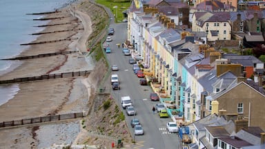 Criccieth featuring a sandy beach and a small town or village