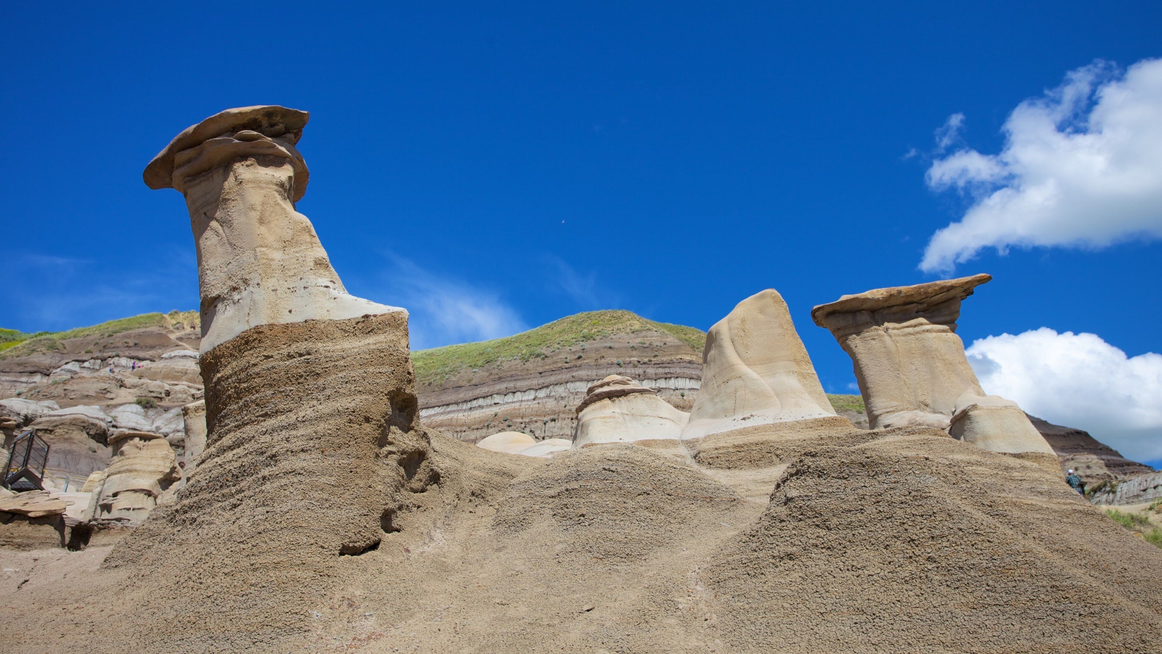 Rock formations with unique shapes against a clear blue sky.