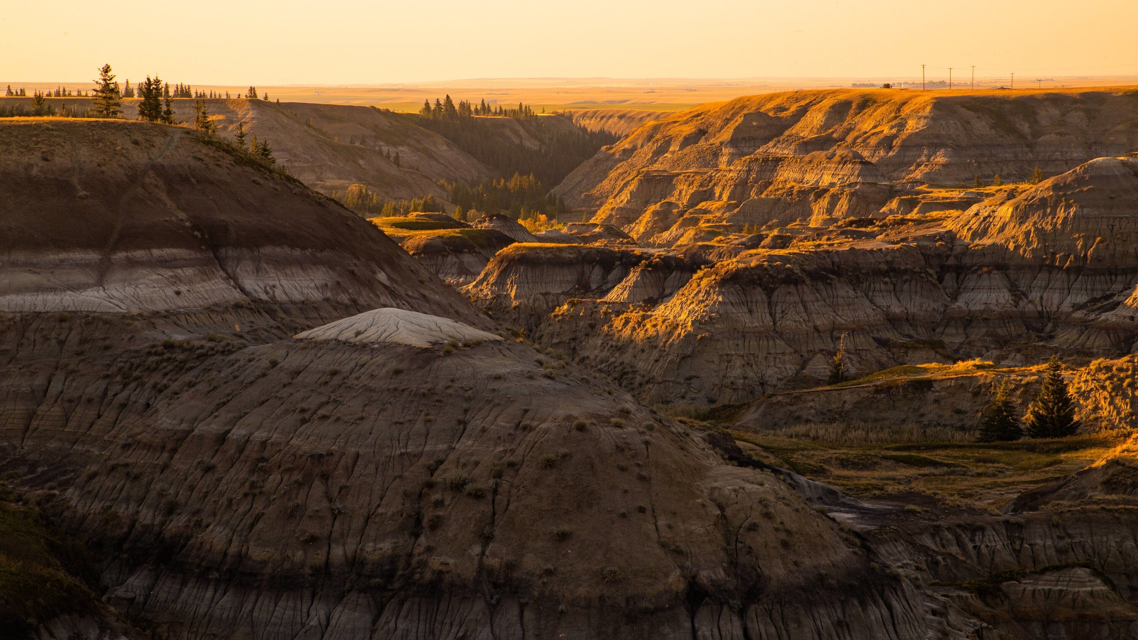 Drumheller showing landscape views, a sunset and a gorge or canyon