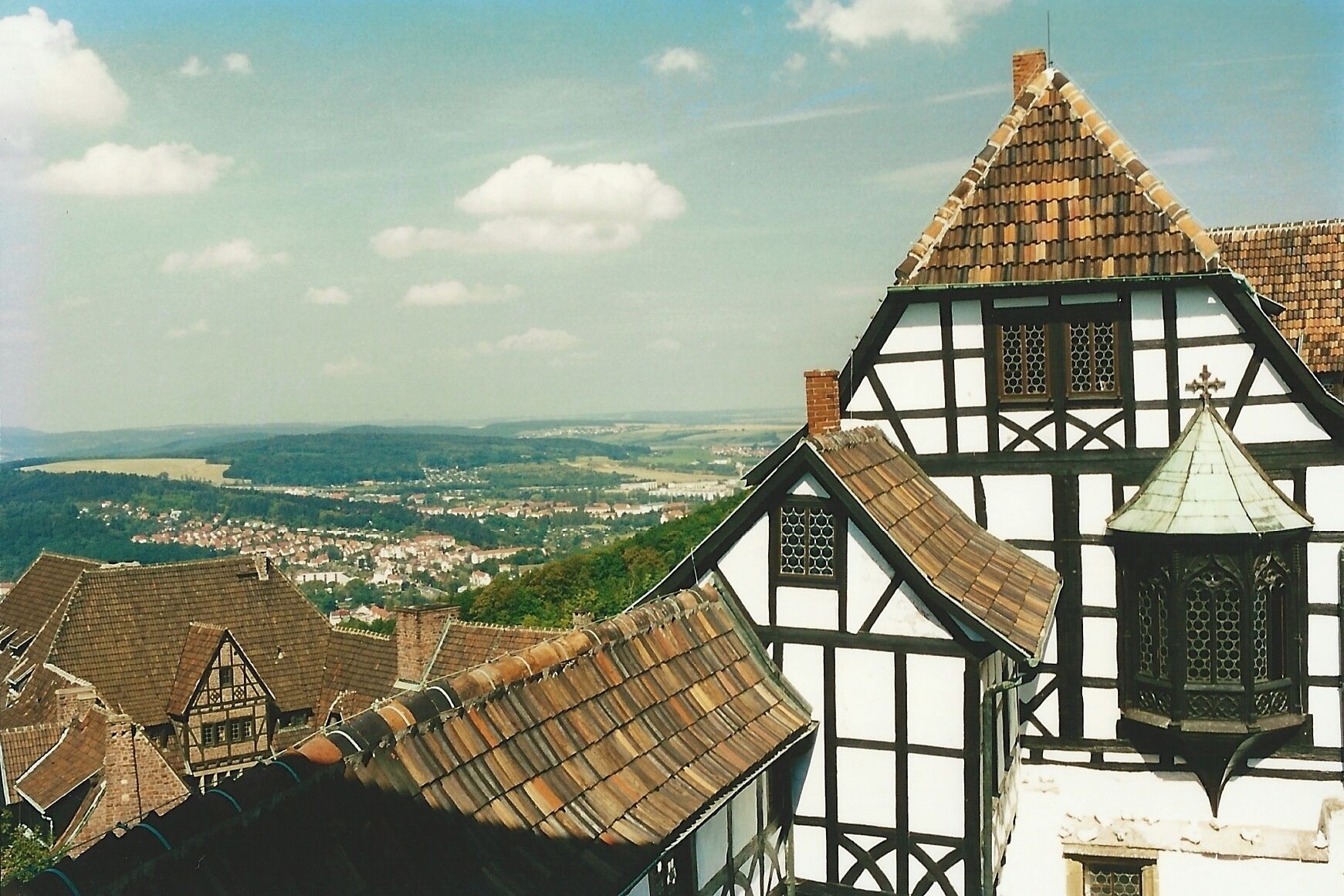 The Wartburg is a castle originally built in the Middle Ages. It is situated on a 410 meters precipice to the southwest of, and overlooking the town of Eisenach, in the state of Thuringia, Germany. In 1999, UNESCO added Wartburg Castle to the World Heritage List. It was the home of St. Elisabeth of Hungary, the place where Martin Luther translated the New Testament of the Bible into German, the site of the Wartburg festival of 1817 and the supposed setting for the possibly legendary Sängerkrieg. It was an important inspiration for Ludwig II when he decided to build Neuschwanstein Castle. Wartburg is the most-visited tourist attraction in Thuringia after Weimar.