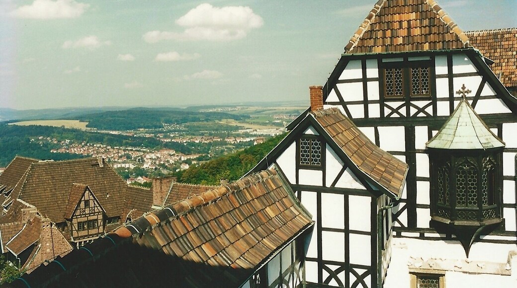 The Wartburg is a castle originally built in the Middle Ages. It is situated on a 410 meters precipice to the southwest of, and overlooking the town of Eisenach, in the state of Thuringia, Germany. In 1999, UNESCO added Wartburg Castle to the World Heritage List. It was the home of St. Elisabeth of Hungary, the place where Martin Luther translated the New Testament of the Bible into German, the site of the Wartburg festival of 1817 and the supposed setting for the possibly legendary Sängerkrieg. It was an important inspiration for Ludwig II when he decided to build Neuschwanstein Castle. Wartburg is the most-visited tourist attraction in Thuringia after Weimar.