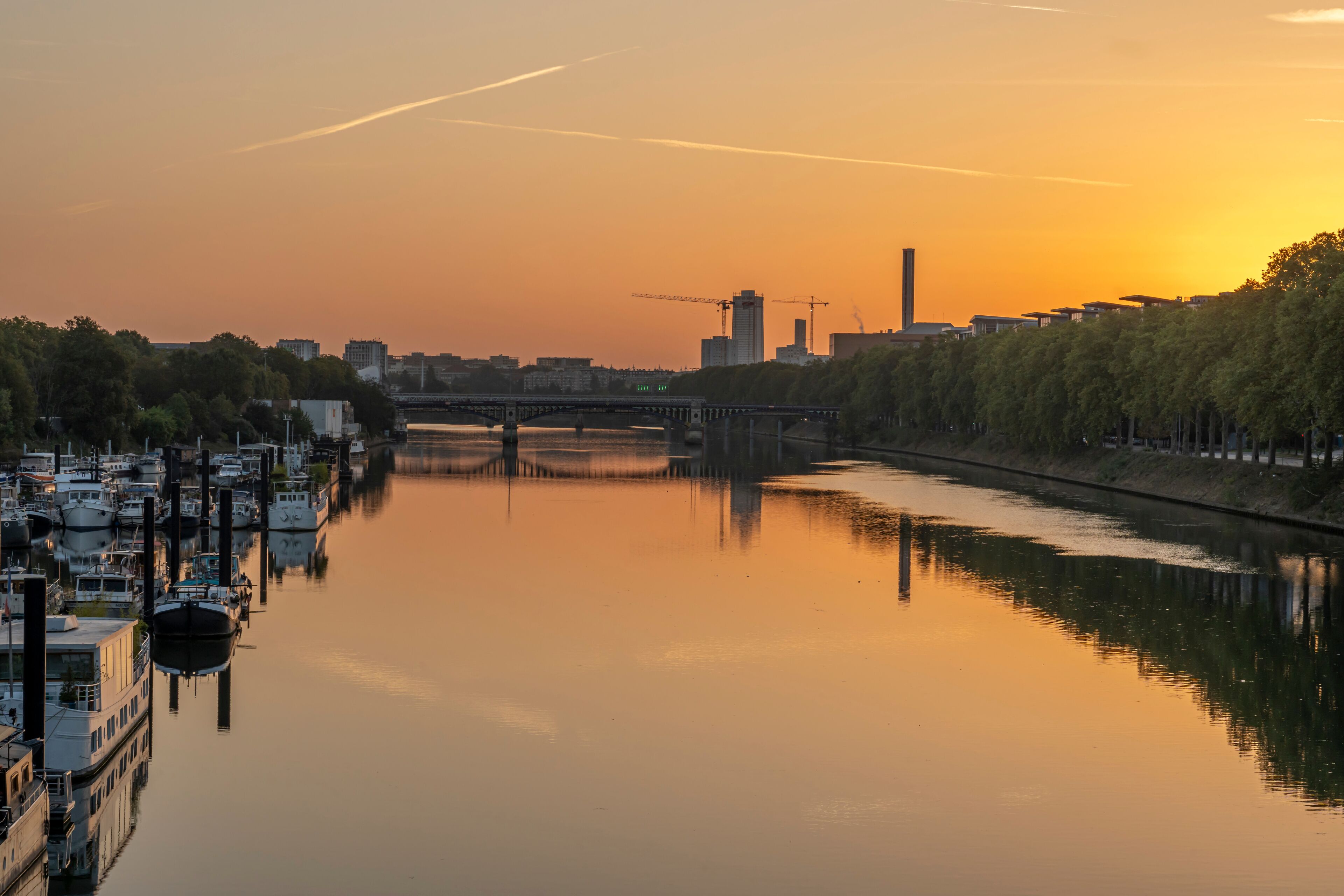 Gennevilliers, France - 05 06 2023: Panoramic view of the Seine river and Saint-Denis district from Clichy bridge at sunrise.