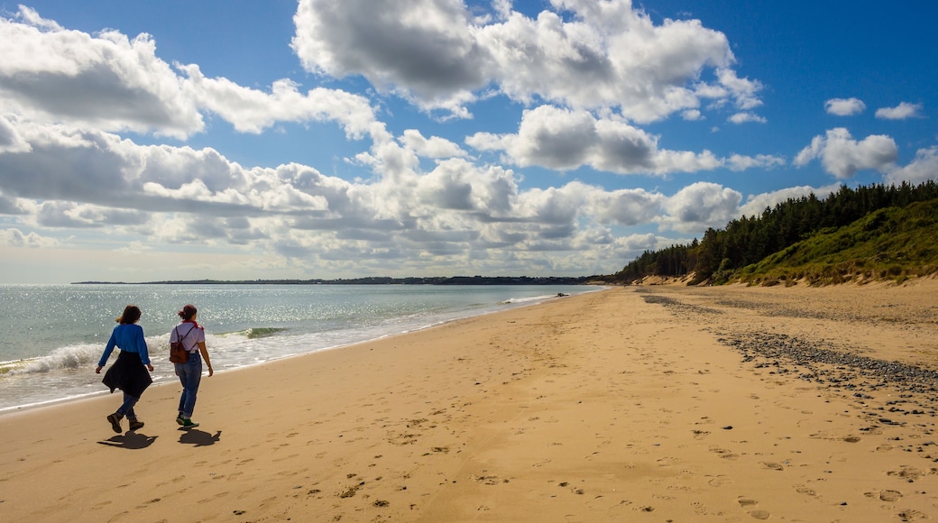 Two people walking down Kiltennel Beach, County Waterfor, Ireland.