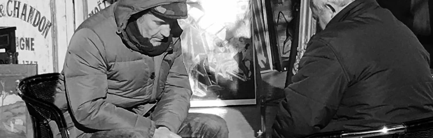 Old gentleman playing chess at a flea market in Paris 2017 February