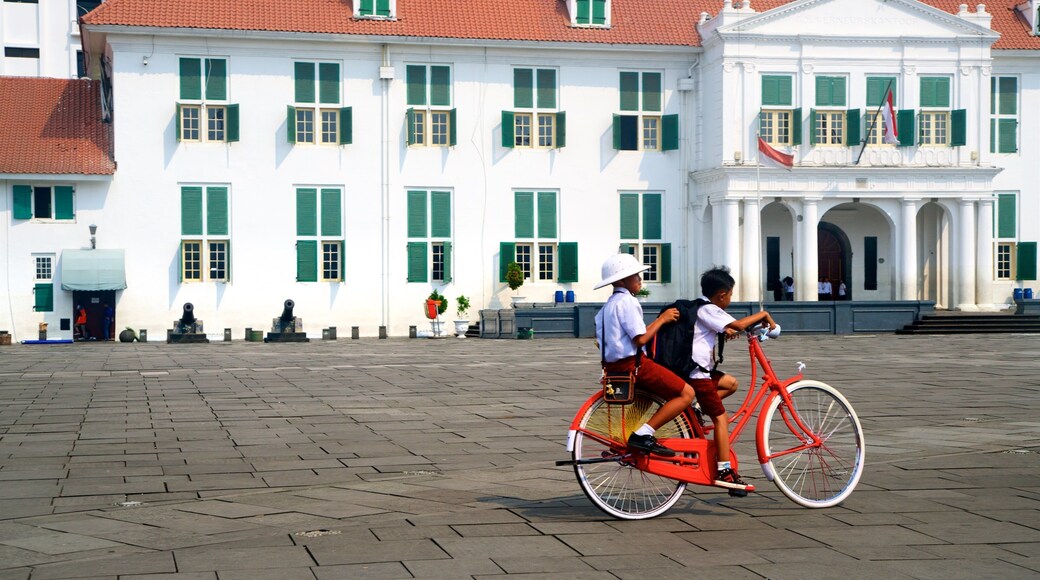 Old Jakarta which includes a square or plaza and road cycling as well as children