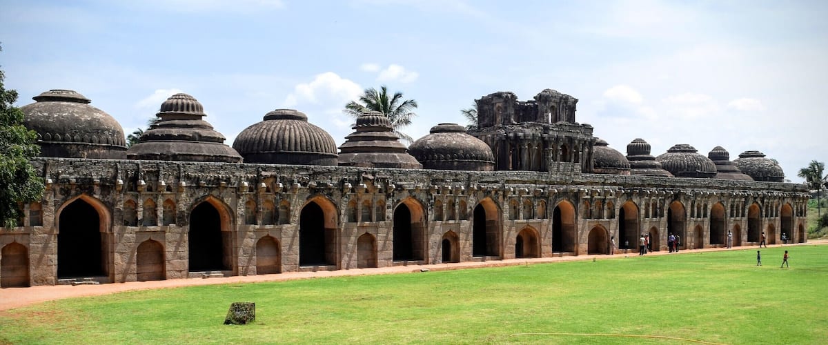 A historic temple complex with multiple domes and arched gateways.