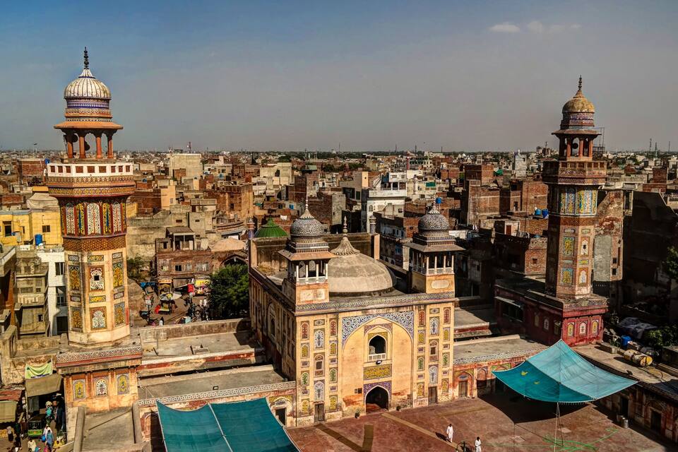 A densely packed urban area with historic buildings featuring domes and intricate tile work.