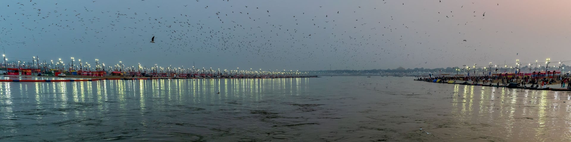 Kumbha Mela, Allahabad, Uttar Pradesh, India; 17-Feb-2019; lights on the river banks, sunset at Sangam, river Ganges